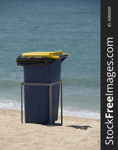 Waste bin sited on a beach for bathers to dispose of their rubbish. Waste bin sited on a beach for bathers to dispose of their rubbish