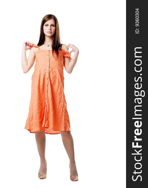 Brunette girl in the orange dress isolated on a white background