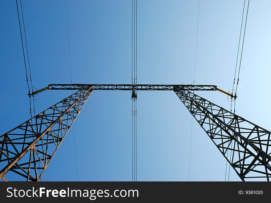 Electricity pylon against the blue sky