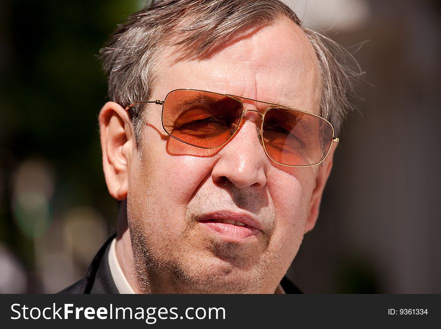 Close up picture of a senior male with Sunglasses. Close up picture of a senior male with Sunglasses