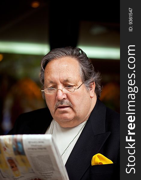 Senior man in the restaurant reading newspaper. Senior man in the restaurant reading newspaper