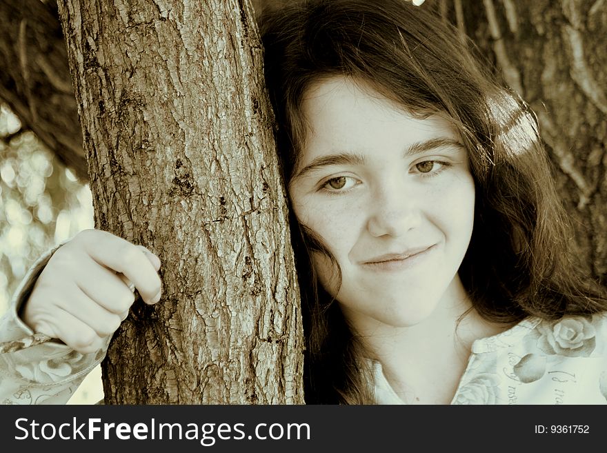 Teen girl leaning on tree beauty