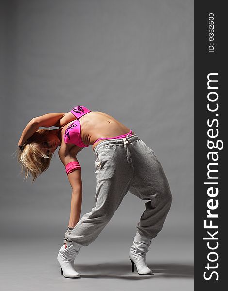 Modern style dancer posing on studio background. Modern style dancer posing on studio background