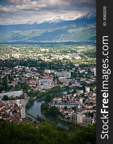 Aerial view of a city with mountains in the background. Grenoble, France. Aerial view of a city with mountains in the background. Grenoble, France.