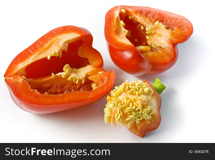 The red pepper cut on two halves and its core with seeds.