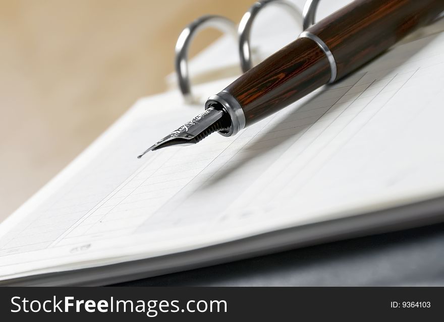 Agenda and ball pen  on a white background