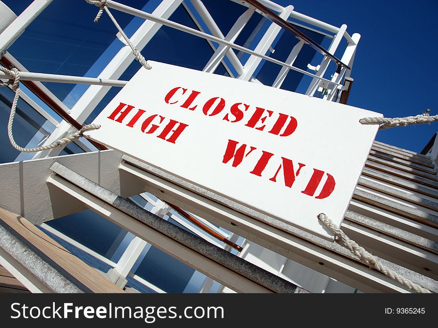 Bold red lettering forbids entry to windswept higher deck of a cruise ship. Bold red lettering forbids entry to windswept higher deck of a cruise ship