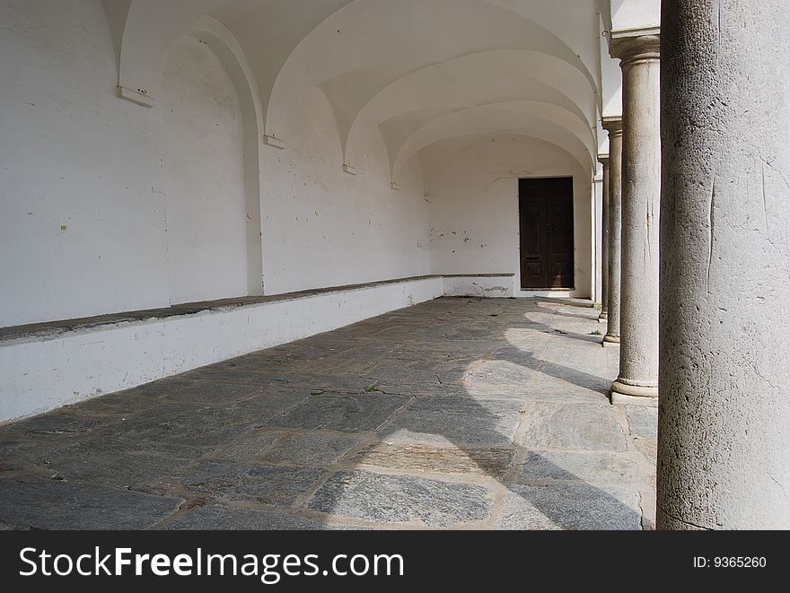 Stone palace gallery with columns and door