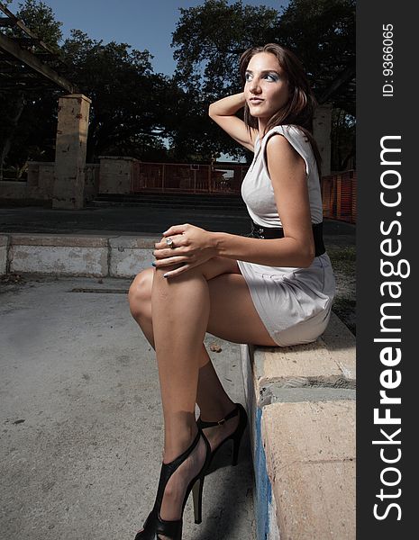 Beautiful young woman with her legs crossed. Beautiful young woman with her legs crossed
