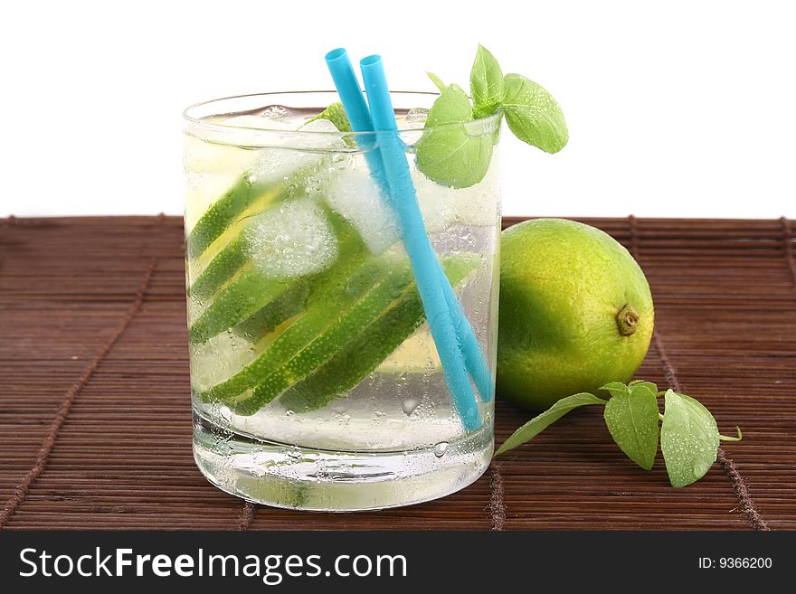 Frosty cold glass of ice water with lime