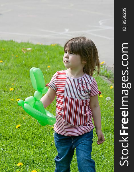 Little girl with green balloon in sunny day. Little girl with green balloon in sunny day