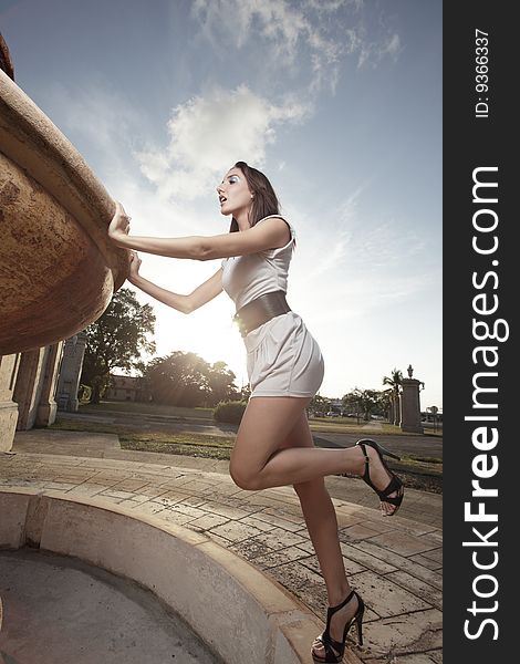 Woman Looking In A Fountain