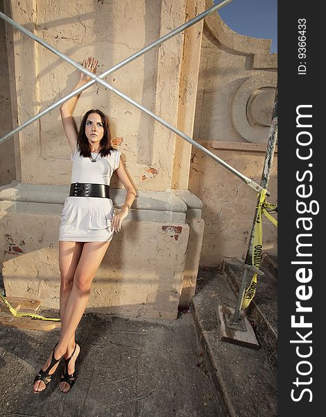 Young model posing by construction scaffolding. Young model posing by construction scaffolding