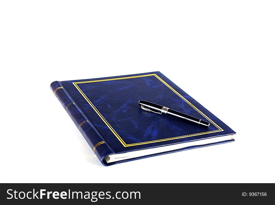 Black pen placed on blue notebook. Black pen placed on blue notebook