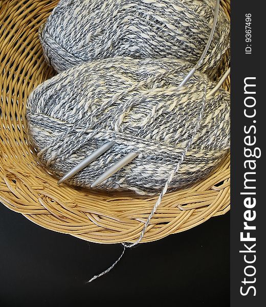 Pied threads bundles in basket, needle. Pied threads bundles in basket, needle