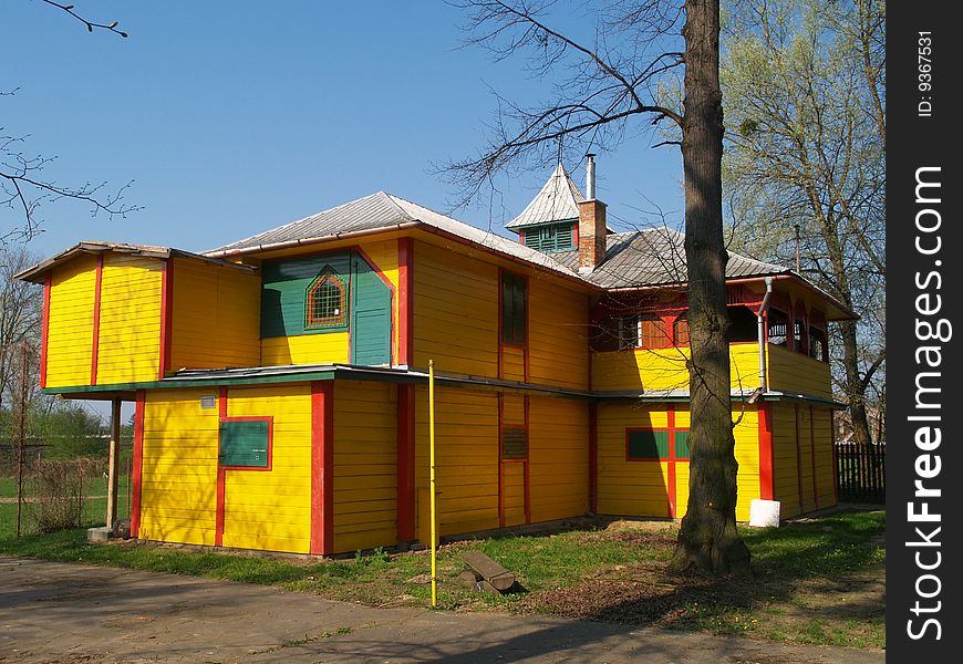 Yellow colored wooden house on river bank