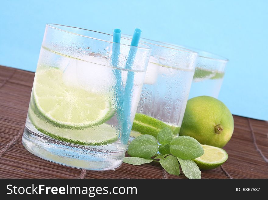 Frosty cold glass of ice water with lime