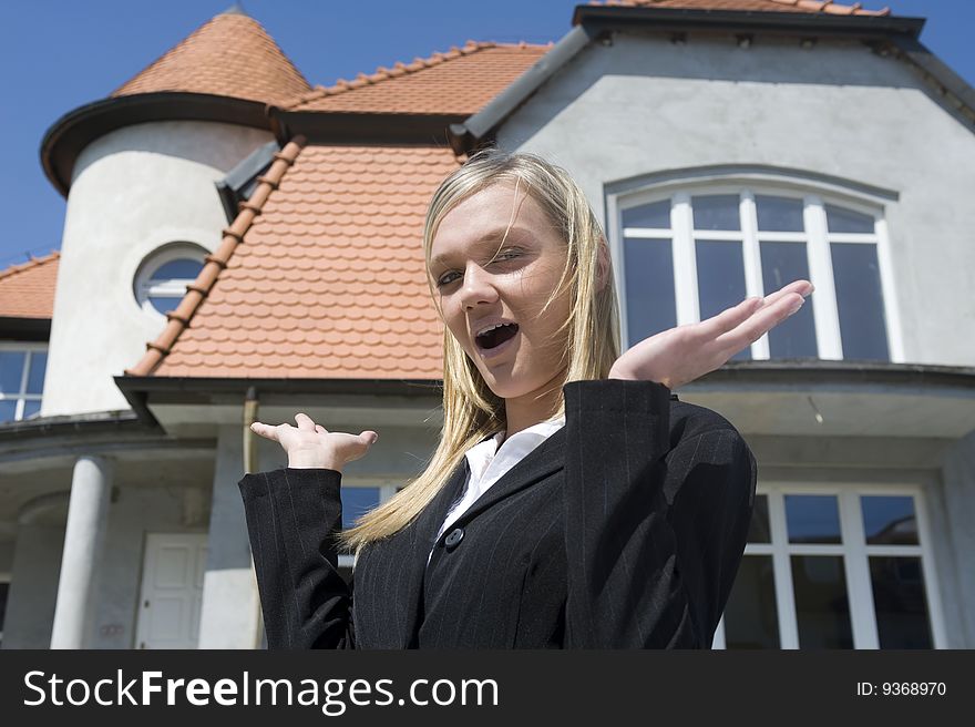 Young woman before one's new house