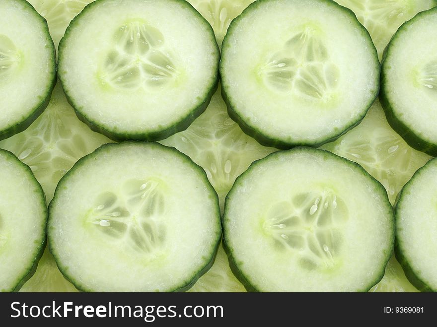 Many cucumber slices filling the frame to create a background. Many cucumber slices filling the frame to create a background.