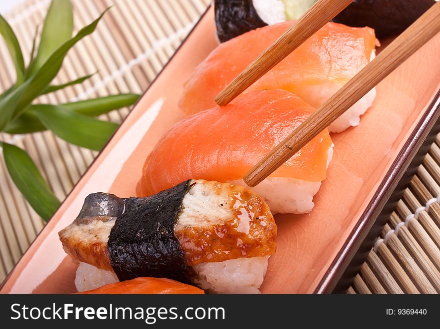 Sushi with chopsticks on a asian plate