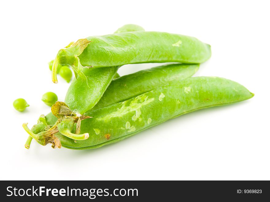 Four whole ripe peapods or english peas containing peas on a white background