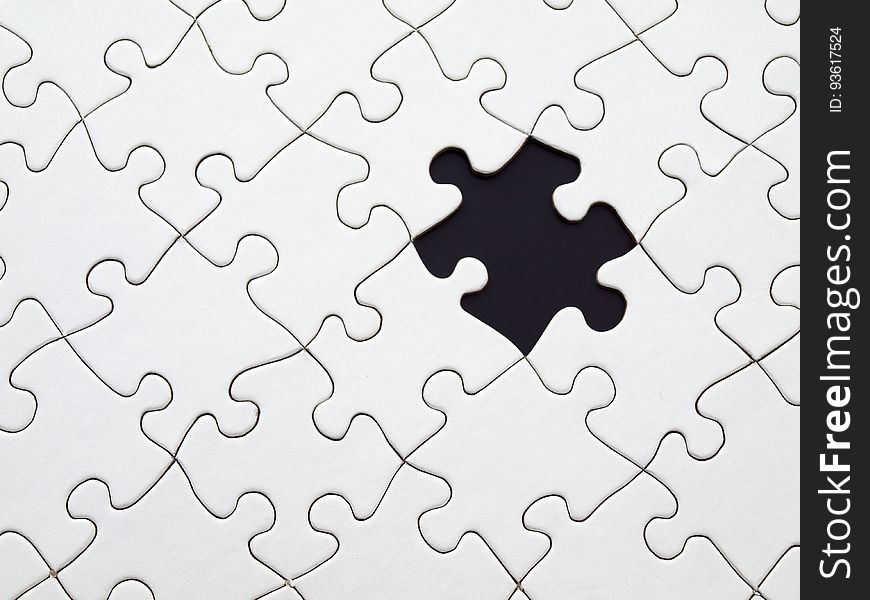 White puzzle pieces fitted together with missing piece. White puzzle pieces fitted together with missing piece.