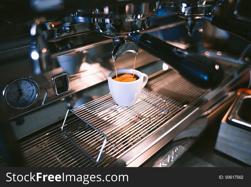 Close up of cup of espresso brewed by machine inside cafe. Close up of cup of espresso brewed by machine inside cafe.