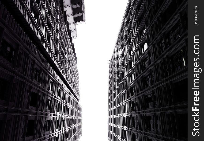 Facade of modern high rise buildings against skies in black and white. Facade of modern high rise buildings against skies in black and white.