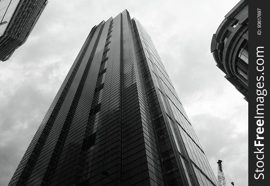 High rise contemporary buildings against cloudy skies in black and white. High rise contemporary buildings against cloudy skies in black and white.