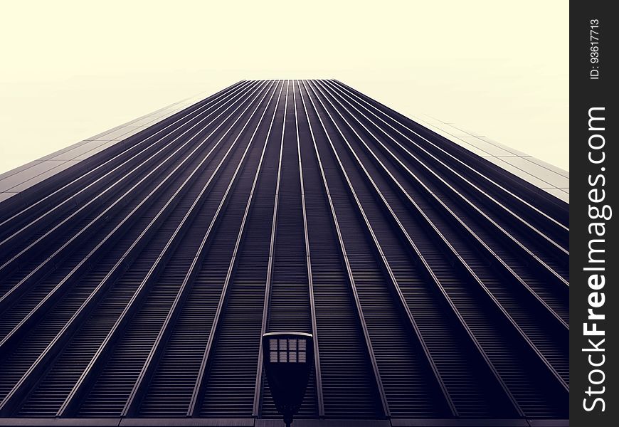 Exterior facade of high rise building against overcast skies.