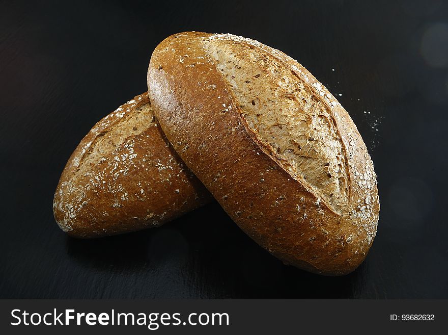 Closeup of loaves of bread isolated on a black background.
