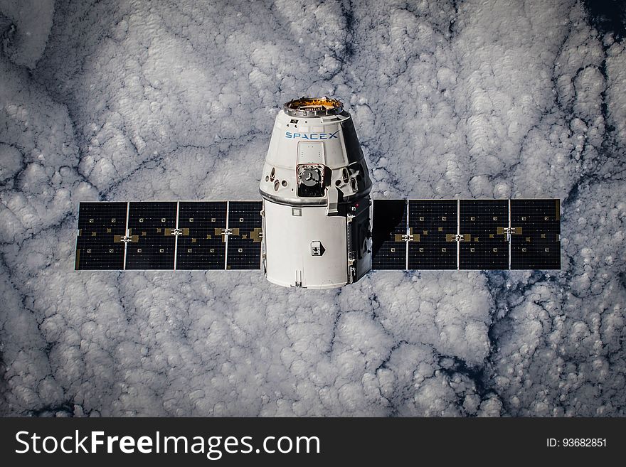 Spacex satellite in orbit over clouds. Spacex satellite in orbit over clouds.