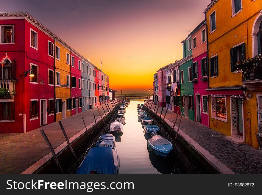 Colorful buildings and boats on a canal in Venice at sunset. Colorful buildings and boats on a canal in Venice at sunset.