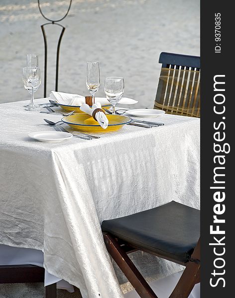 Isolated Dining table on white beach sand. Isolated Dining table on white beach sand