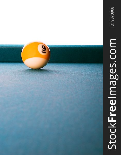 Clean billiards composition with nine ball on blue felt with white background. Clean billiards composition with nine ball on blue felt with white background