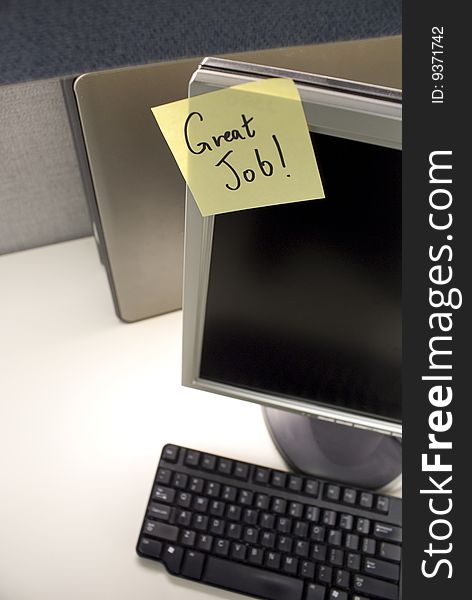 PC at desk with good job note. PC at desk with good job note