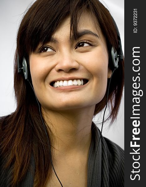 Happy asian young woman with headphone listening music on white background. Happy asian young woman with headphone listening music on white background