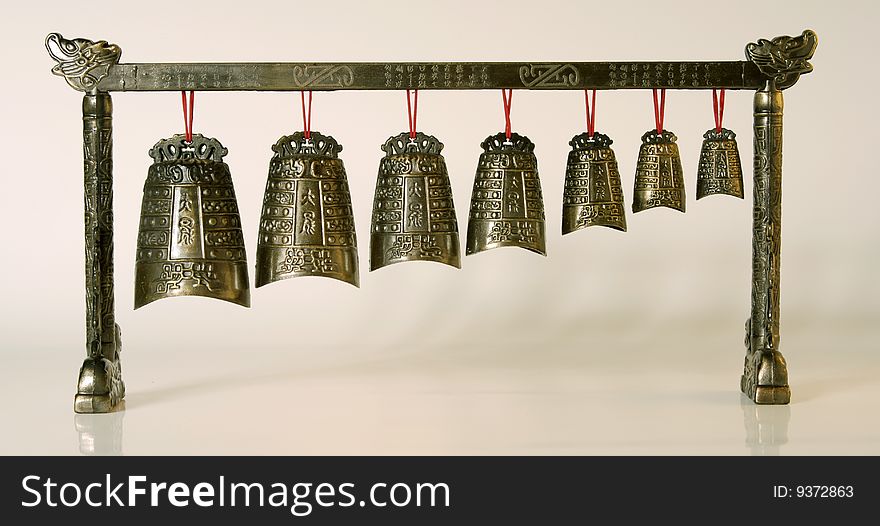 Chinese ancient bronze bell(reproduction) on the white background. Chinese ancient bronze bell(reproduction) on the white background.