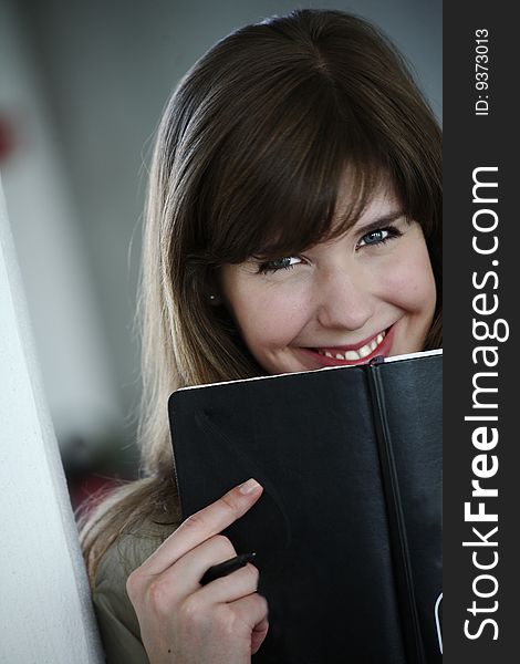 young chick smiling over book. young chick smiling over book