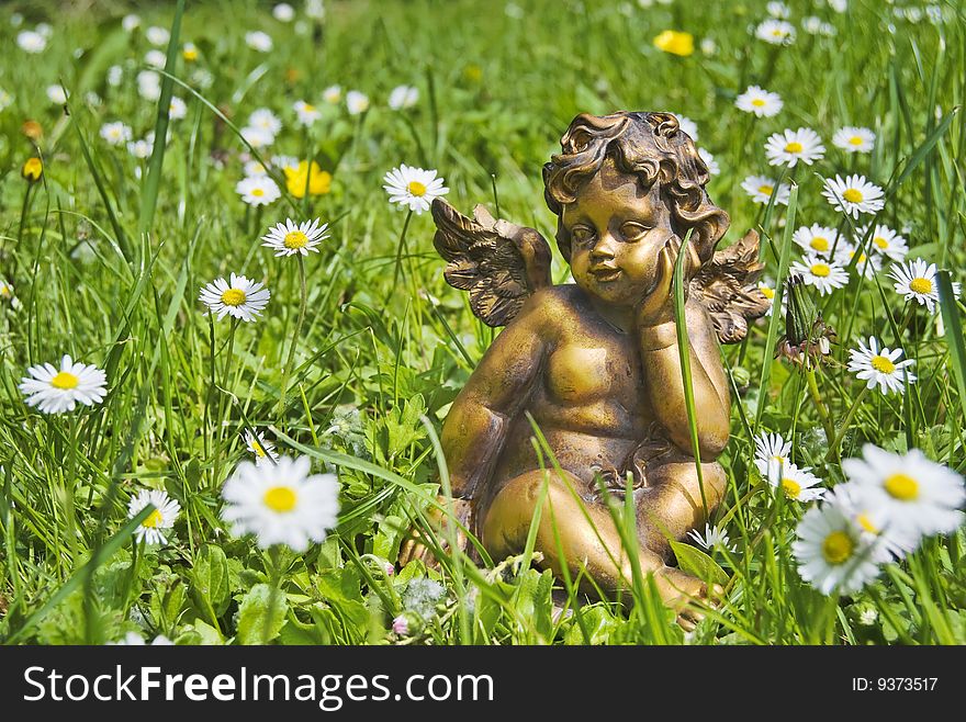 Angel in grass with flowers