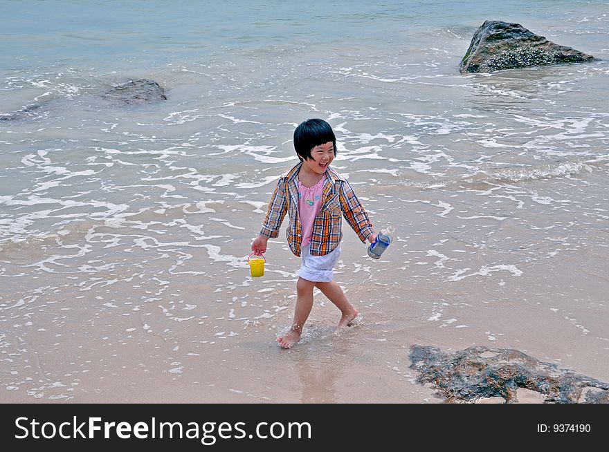 A little girl playing on the beach