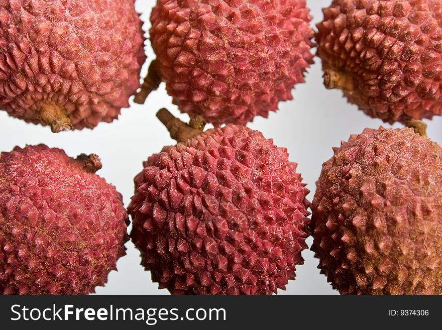 A selection of lychees against a white background. A selection of lychees against a white background