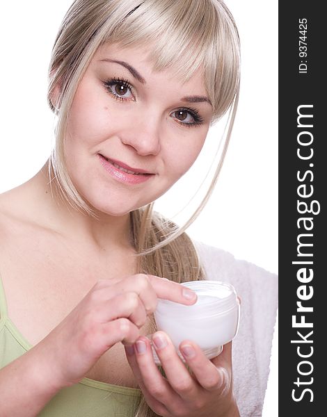 Attractive woman applying cream over white background. Attractive woman applying cream over white background