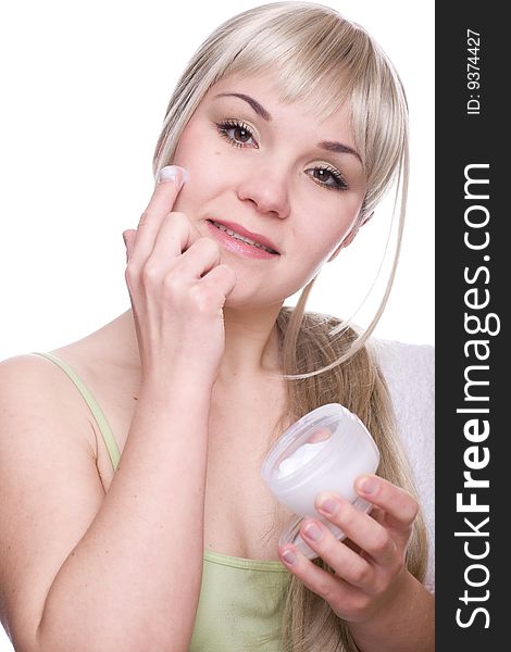 Attractive woman applying cream over white background. Attractive woman applying cream over white background
