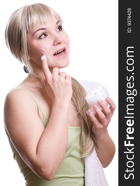 Attractive woman applying cream over white background. Attractive woman applying cream over white background