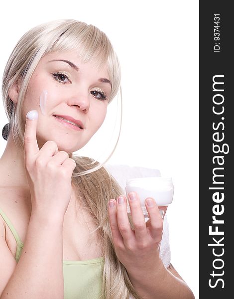 Attractive woman applying cream over white background. Attractive woman applying cream over white background