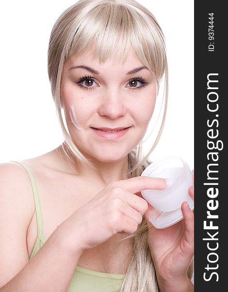 Attractive woman applying cream over white background. Attractive woman applying cream over white background