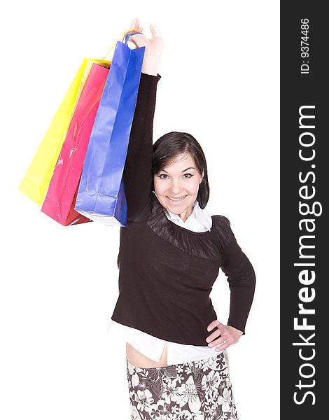 Attractive brunette woman with shopping bags. over white background