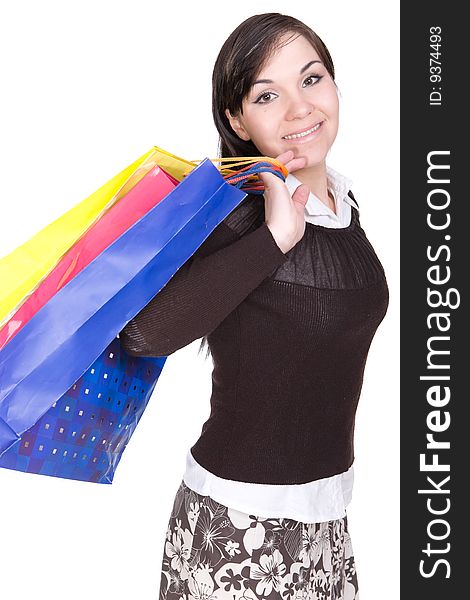 Attractive brunette woman with shopping bags. over white background