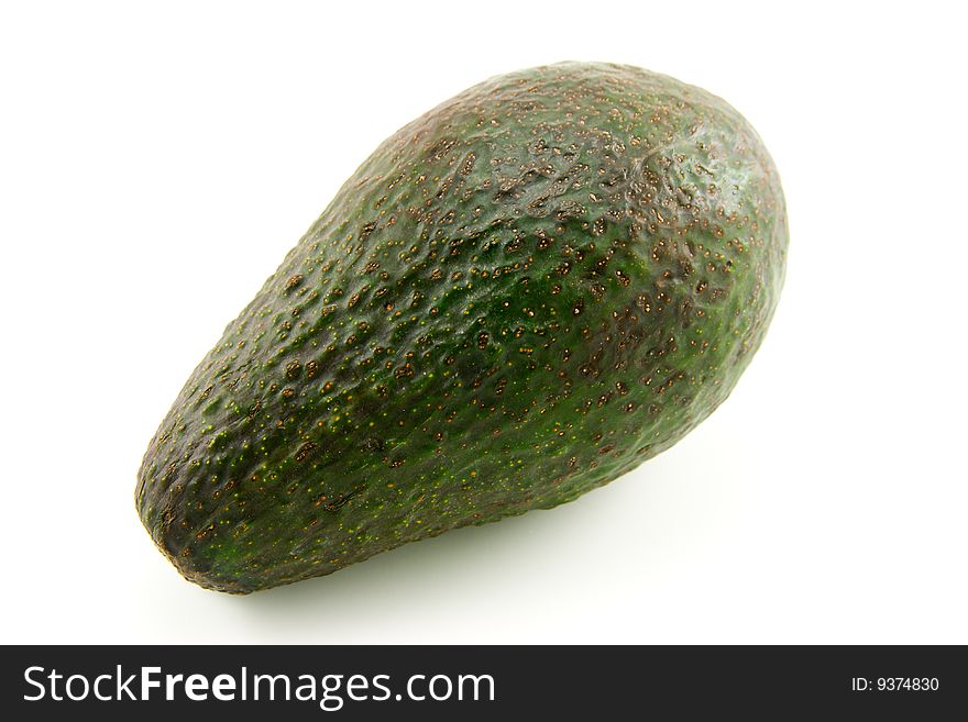 Single whole dark green avocado fruit on a white background. Single whole dark green avocado fruit on a white background